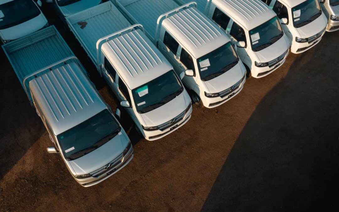 Fleet of commercial vans, representing business vehicle expenses and asset management for tax and accounting purposes.